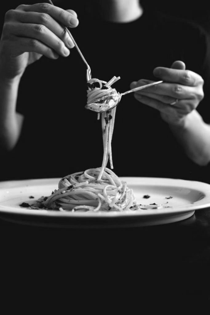 Guest enjoying freshly served pasta
