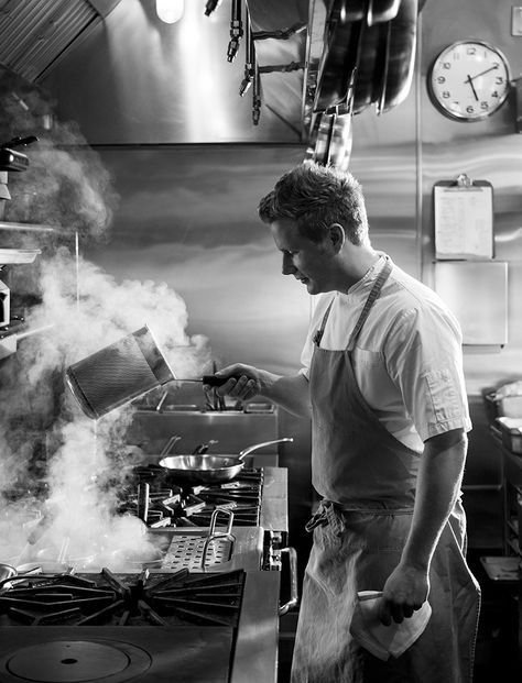 Chef working over a busy restaurant stove